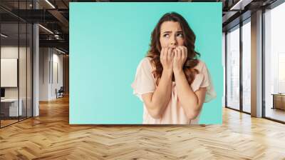 Portrait of a frightened young girl in dress looking away Wall mural