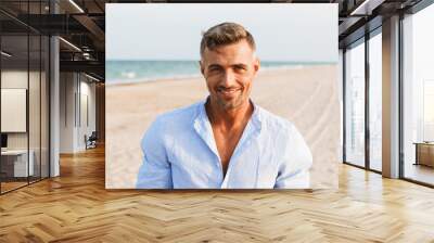 Portrait of a handsome smiling man in shirt Wall mural