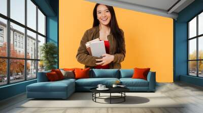 Portrait of a happy pretty asian girl holding books Wall mural