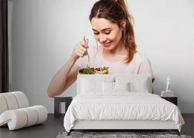 Portrait of a happy pretty girl eating fresh salad Wall mural