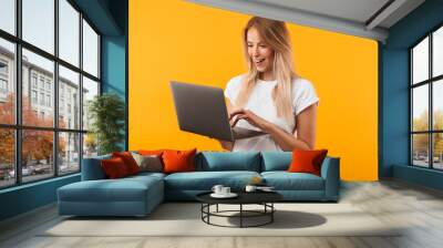 portrait of a happy young blonde girl using laptop computer Wall mural