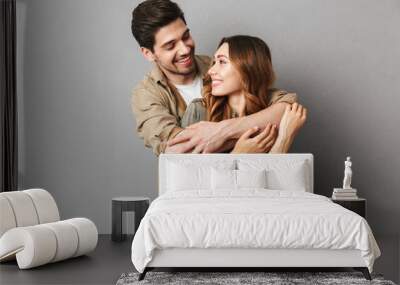 Portrait of a happy young couple hugging Wall mural