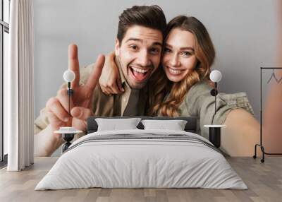 Portrait of a happy young couple hugging Wall mural