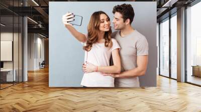 Portrait of a happy young couple hugging Wall mural