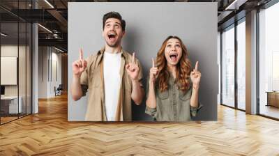 Portrait of a happy young couple standing together Wall mural