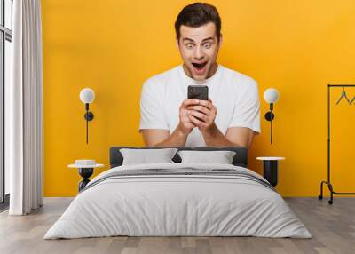 Portrait of a happy young man wearing t-shirt standing Wall mural