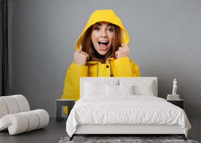 Portrait of a joyful girl dressed in raincoat Wall mural