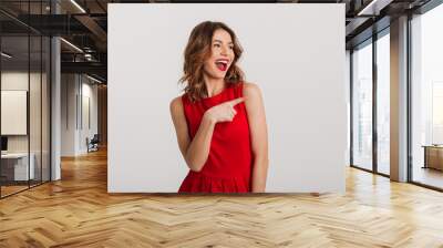 Portrait of a joyful young woman dressed in red dress Wall mural