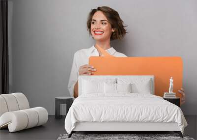 Portrait of a joyful young woman standing Wall mural