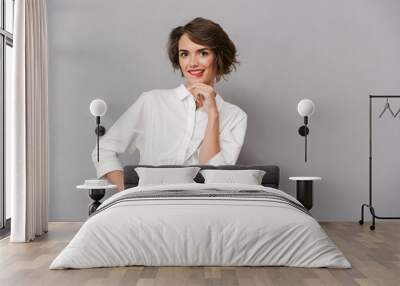 Portrait of a pensive young woman dressed in white shirt Wall mural