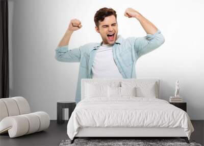 Portrait of a satisfied young man celebrating success Wall mural