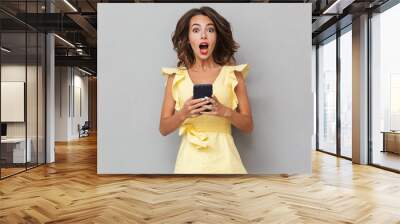 Portrait of a shocked young girl in dress Wall mural