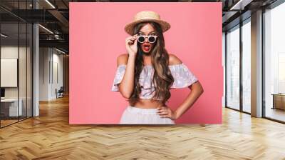 Portrait of a shocked young girl in summer clothes Wall mural