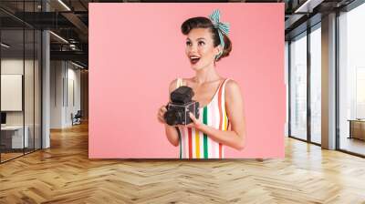 Portrait of a smiling brunette pin-up girl in plaid shirt Wall mural