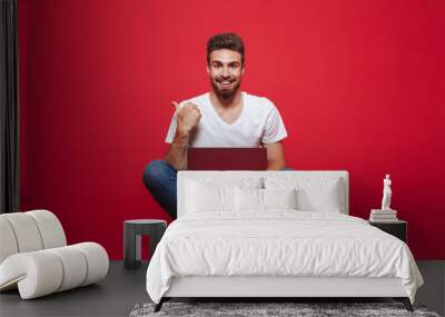 Portrait of a smiling young bearded man Wall mural