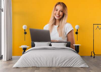 Portrait of a smiling young blonde girl Wall mural