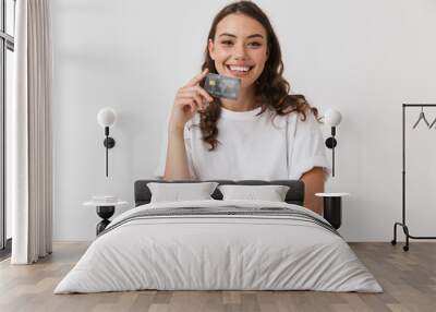 Portrait of a smiling young casual brunette woman Wall mural