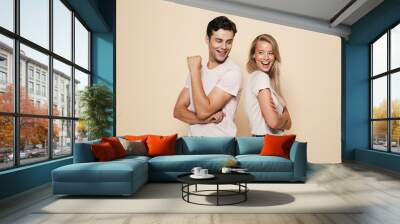 Portrait of a smiling young couple standing together Wall mural