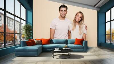 Portrait of a smiling young couple standing together Wall mural