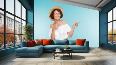 Portrait of a smiling young woman in summer hat Wall mural