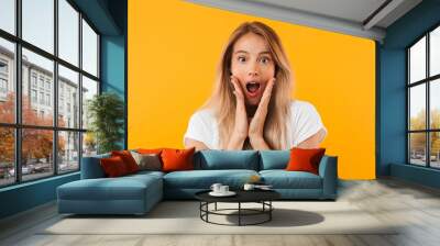 Portrait of a surprised young blonde girl Wall mural