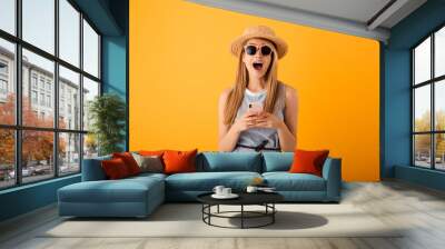 Portrait of an excited young blonde woman in summer hat Wall mural