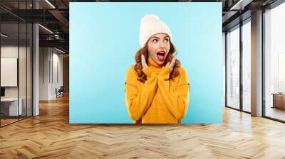 Portrait of an excited young girl dressed in winter clothes Wall mural