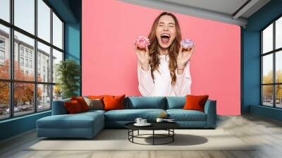 Portrait of an excited young woman showing pastry Wall mural