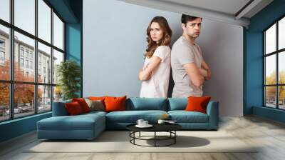 Portrait of an upset couple standing back to back Wall mural