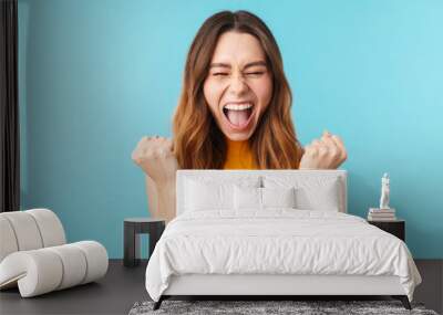 Portrait of beautiful joyous woman screaming and gesturing as winner Wall mural