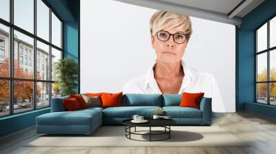 Portrait of caucasian adult woman wearing eyeglasses looking at camera Wall mural