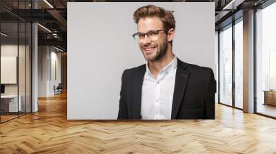 Portrait of joyful young businessman posing at camera and smiling Wall mural