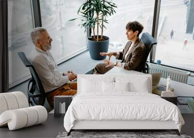 Portrait of professional man and woman sharing ideas during meeting in conference room Wall mural