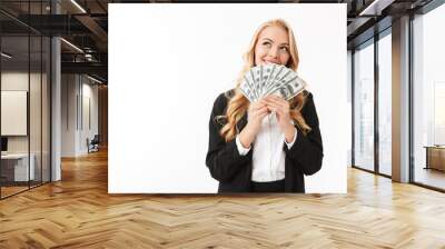 Portrait of successful woman wearing office clothing holding fan of money, isolated over white background Wall mural