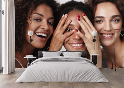 Portrait of three multiracial women standing together and smiling Wall mural