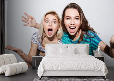 Portrait of two cheerful young female teens having fun together Wall mural