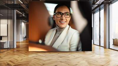 Positive pleased business woman sitting in a car Wall mural