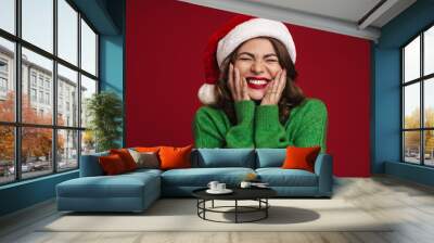 Positive young woman in christmas santa hat Wall mural