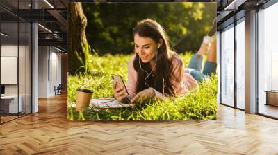 Prett young girl student using mobile phone Wall mural