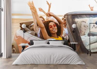 Pretty happy smiling cheery young pretty women friends driving the car. Wall mural