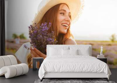 Pretty young girl in straw hat Wall mural