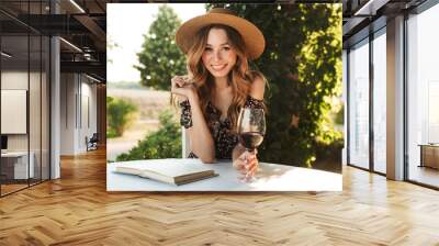 Pretty young woman drinking wine. Wall mural