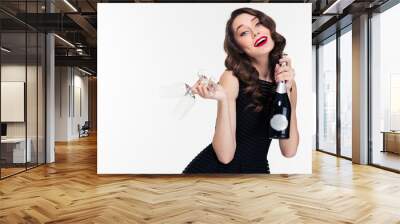 Relaxed attractive happy curly woman with champagne and glasses Wall mural