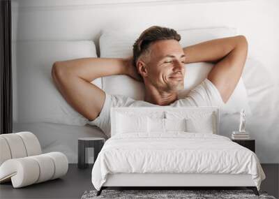 Satisfied man relaxing in bed Wall mural