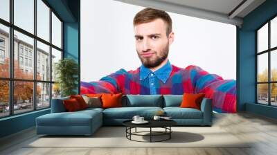 Selfie photo of attractive confident young man in plaid shirt Wall mural