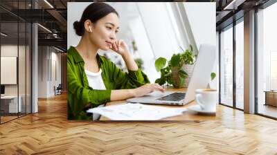 Smiling beautiful young asian woman working on laptop Wall mural