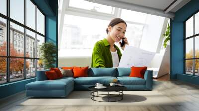 Smiling beautiful young asian woman working on laptop Wall mural