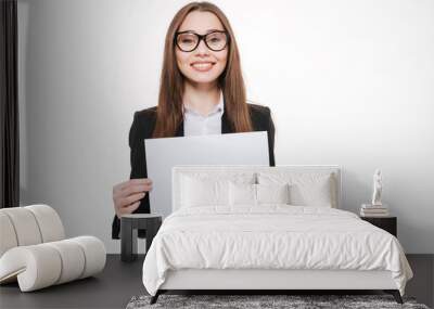 Smiling businesswoman holding blank board isolated on a white background Wall mural