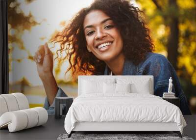 Smiling young african girl in denim jacket Wall mural