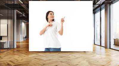 Smiling young casual woman standing isolated Wall mural